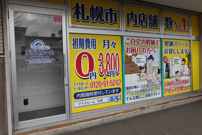 プラスルーム札幌清田2条店の入口と店頭の料金案内看板